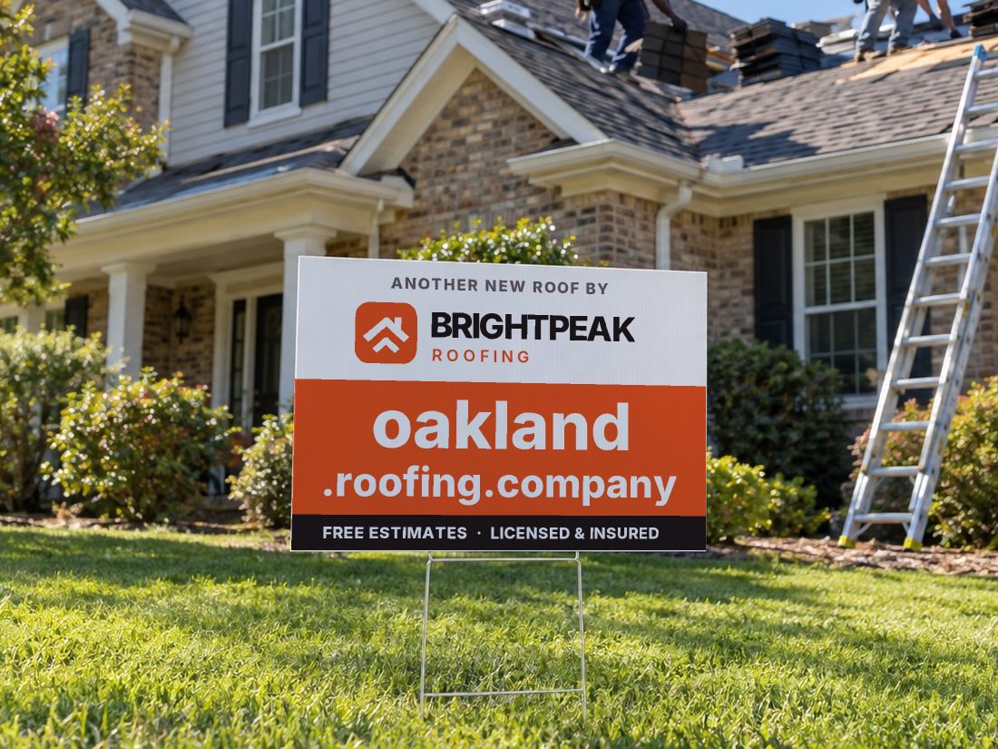 oakland.roofing.company on a yard sign in front of a house getting a new roof